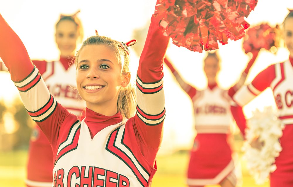 High school football team show incredible compassion to cancer-stricken cheerleader.